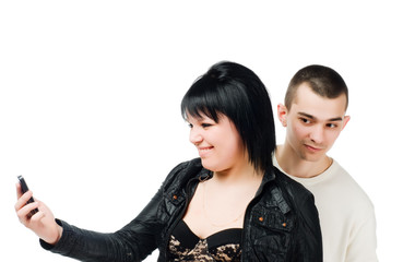 Young woman with cell phone and guy eavesdropping