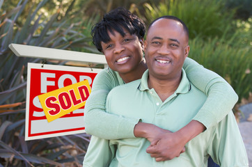 Happy Couple and Real Estate Sign