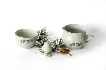 tableware and  pine branch on white background