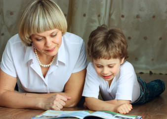woman and little boy reading book