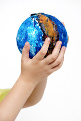 Children's hands holding globe made the child