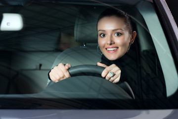 young pretty woman driving car