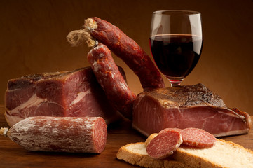 mix of parma prosciutto and salami with bread glass of wine