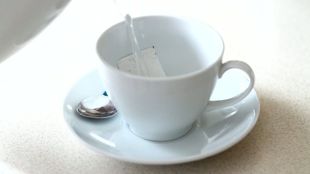 Preparing tea in white cup