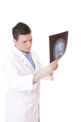 Caucasian mid adult male doctor holding up xrays.