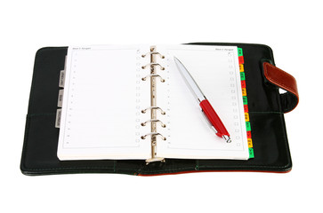 Open leather office organizer with a red pen