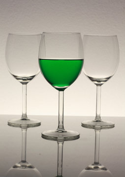 wine glasses with green wine