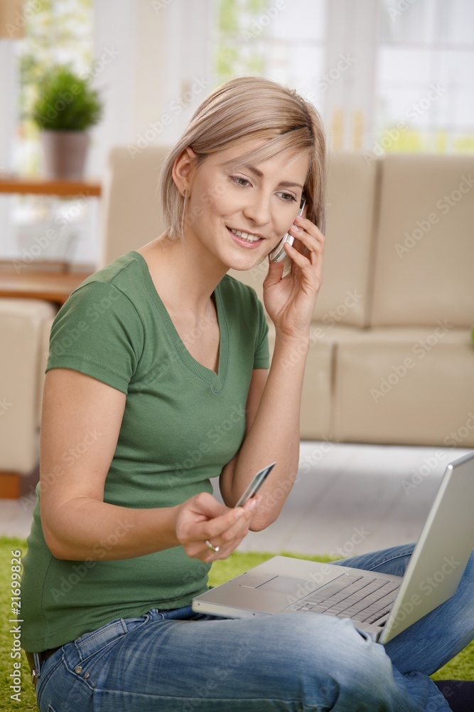 Wall mural Woman paying bills from home