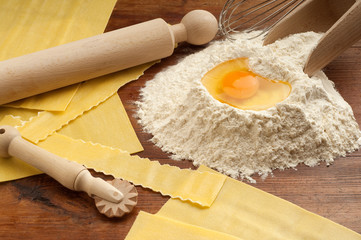 raw  egg pasta with flour and rolling pin