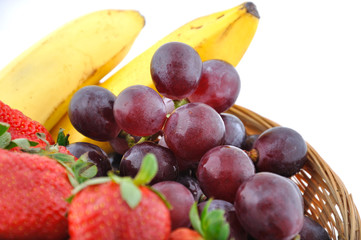 Fototapeta na wymiar Basket of srawberries, grapes and banana