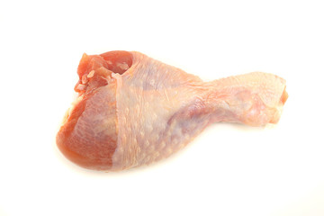 Raw chicken leg on white background