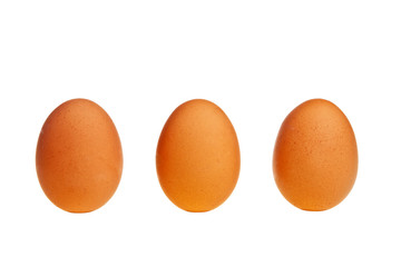 Three brown eggs in vertical position.