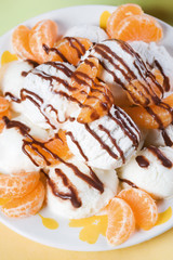 Scoops of vanilla ice cream and sliced tangerine