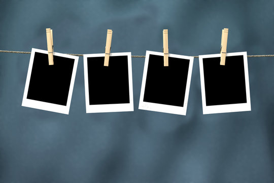 Four empty photos hanging from clothesline with clipping path