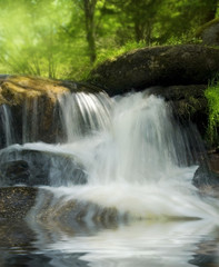 Fototapeta na wymiar brook with big stones and waterfall