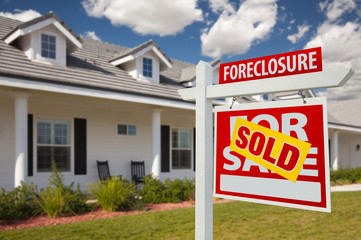 Fototapeta na wymiar Sold Foreclosure Real Estate Sign and House - Right