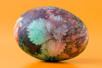 colorful ornate easter egg, isolated on orange background