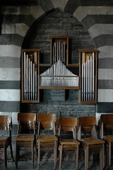 Old organ pipes and chairs