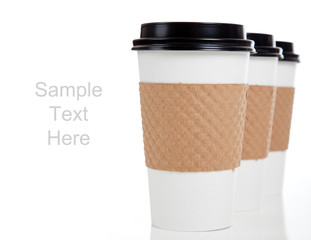 Row of paper coffee cups on white with copy space