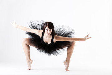 Young beautiful ballet dance holding difficult pose
