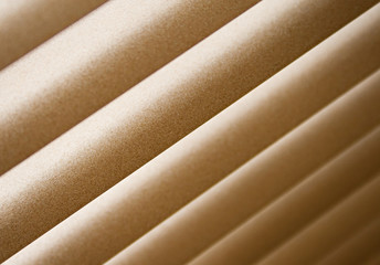 Closed horizontal window blinds with sun light