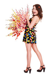 Beautiful girl with spring flower in polka dot dress. Isolated.