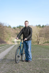 Men standing with trekking bike