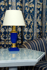 Fragment of living room decorated by blue curtain