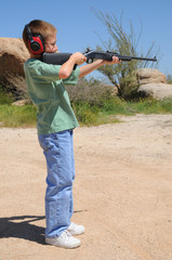 Young boy shooting a rifle