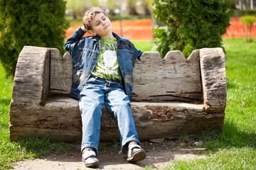 Cute kid sitting on bench