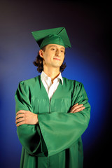 portrait of a succesful man on his graduation day in green