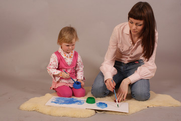 Fototapeta premium young mother with her daughter drawing