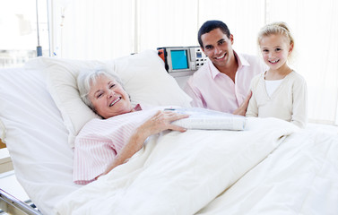 Smiling little girl with her father visiting her grandmother