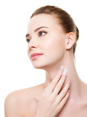 Obraz na płótnie Canvas Woman applying moisturizer cosmetic on neck