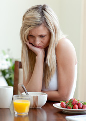 Obraz na płótnie Canvas Tired woman having an healthy breakfast