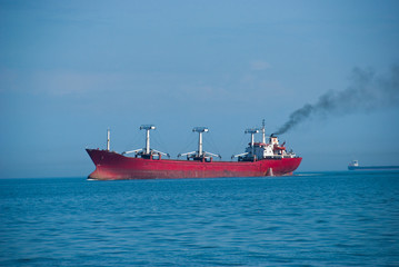 The industrial vessel - the dry-cargo ship goes to port