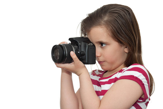 Young girl taking a picture with a professional camera