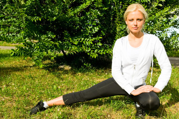 young woman doing exercises in park