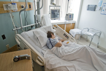 Patient recuperating from surgery in hospital room