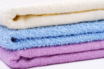 Stack of colorful towels on white