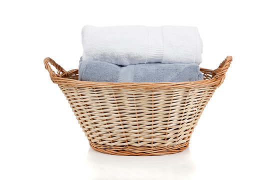 White And Blue Towels In A Laundry Basket On White