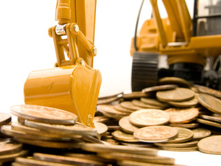 Yellow excavator digging a heap of coins