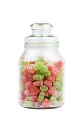 Candy in a glass jar on white background.