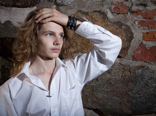 A teenage heavy rocker grooming his hair.