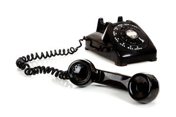A  vintage black telephone  on a white background