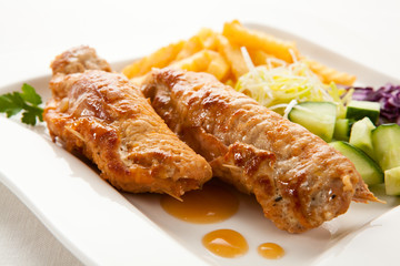 Roasted stuffed pork chop with chips and vegetables