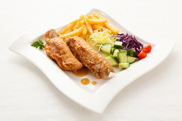 Roasted stuffed pork chop with chips and vegetables