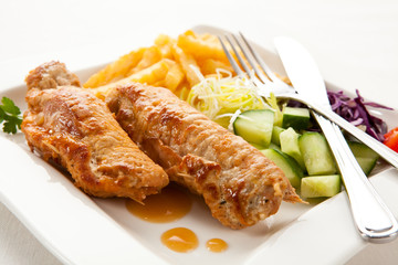 Roasted stuffed pork chop with chips and vegetables