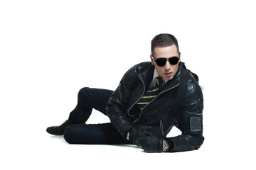 cool young man in leather jacket lying down