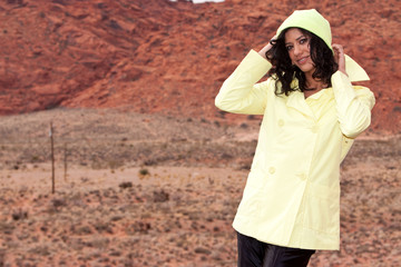 Fototapeta premium Young African American woman in raincoat